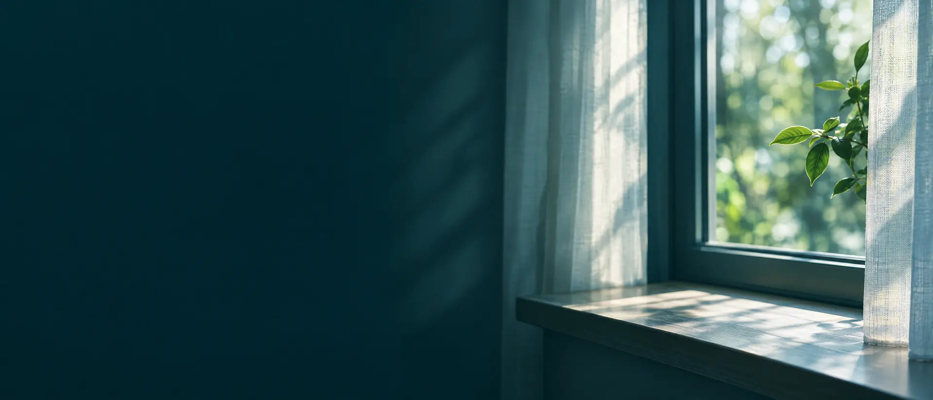 Sunlit empty window sill and soft curtains in a quiet home