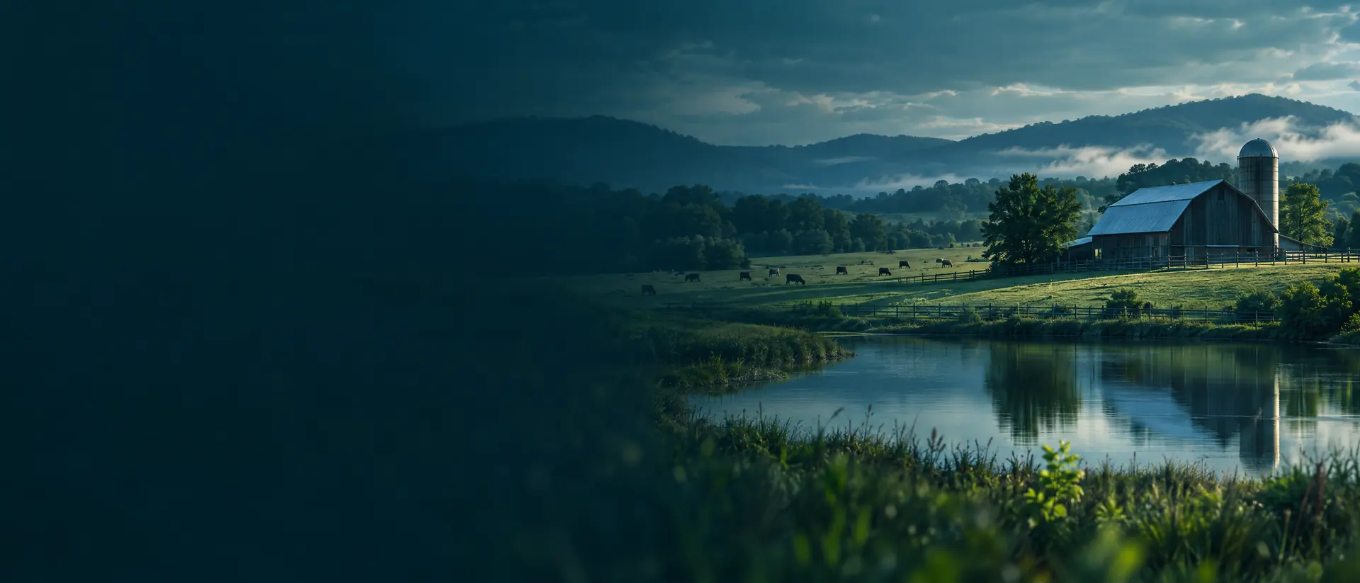 Pastoral scene with a barn, pond and pasture with distant livestock