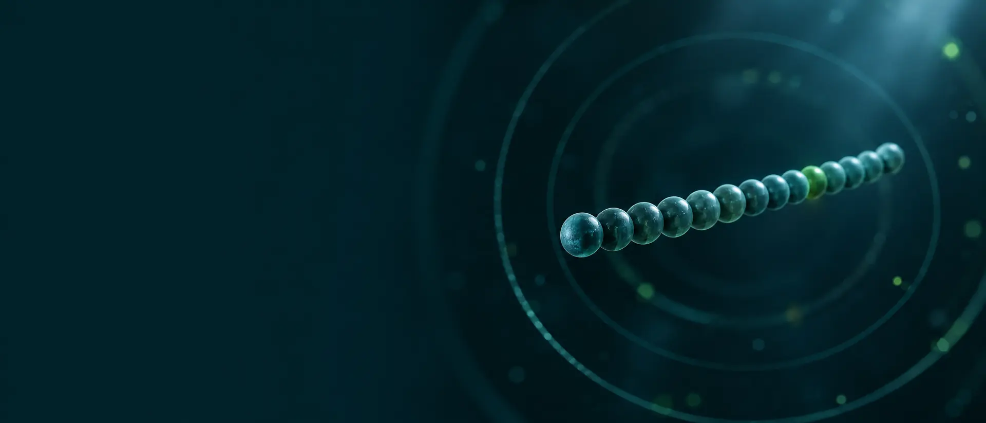 Short chain of teal spheres suspended in dark space with faint concentric rings
