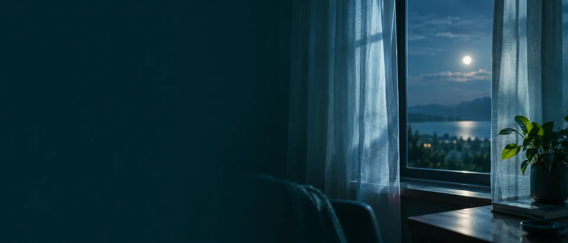 Dusk window with deep blue sky and moonlight on sheer curtains