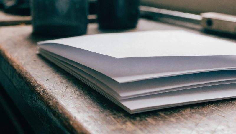 A folded product label booklet lying open on a workbench.